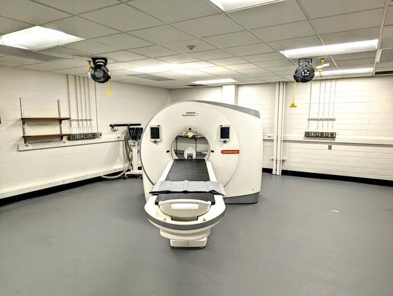 An MRI machine in the middle of a white walled room