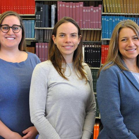 Emma Leof Bollig, Dr. Amanda Beaudoin, and Dr. Jennifer Granick pose in front of bookcase